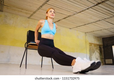 Healthy Lifestyle, Activity, Fitness, Sport. Woman Doing Reverse Push Ups Using Chair. Back And Arms Workout Without Equipment In Gym