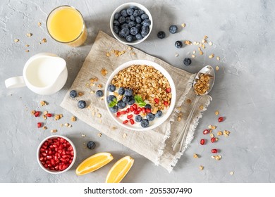 Healthy lifestyle in a breakfast plate with muesli and a spoon with milk, berries and orange juice. Muesli food with nut grains, organic muesli, morning diet, oatmeal for health concept - Shutterstock ID 2055307490