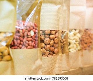 Healthy Lifestyle, Clean And Natural Food. Nuts - Raisins, Peanuts, Hazelnuts. Packed In Paper Bags, Stand On The Counter In The Store