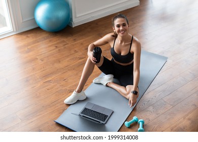 Healthy Lifestyle Concept. Above Top High Angle View Of Cheerful Fit Lady In Sportswear And Sheakers Sitting On Yoga Mat, Using Laptop, Watching Video Or Having Online Class, Looking Up At Camera