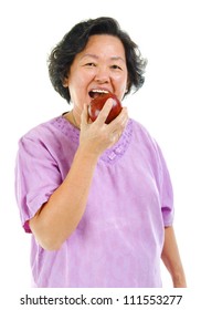 Healthy lifestyle concept. Asian senior woman eating an apple over white background