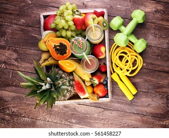 Healthy lifestyle concept. sport fitness equipment-several bottles with fruit and berry juices smoothies and milkshakes , jumping rope