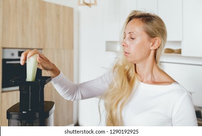 Healthy Lifestyle Concept. Woman 30-40 Years Old Cooking Detox Cocktail For Breakfast At Home In The Kitchen