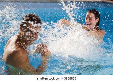 Healthy lifestyle: couple having fun at the swimming pool - Powered by Shutterstock