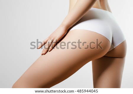 Healthy lifestyle diet and fitness. Beautiful slim woman's body. Perfect slim toned young body of the girl. Fitness or plastic surgery and aesthetic cosmetology. Taut elastic ass. Firm buttocks
