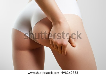 Healthy lifestyle diet and fitness. Beautiful slim woman's body. Perfect slim toned young body of the girl. Fitness or plastic surgery and aesthetic cosmetology. Taut elastic ass. Firm buttocks