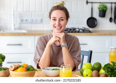 Healthy Lifestyle, Diet, Weight Loss Concept. Beautiful Happy Woman Eats Breakfast Looking At Camera And Smiling Friendly. Beautiful Female Eating Fresh Salad While Sitting In Her Kitchen Vegan Meal