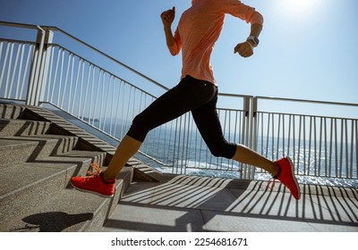 Healthy lifestyle fitness sports woman runner running on seaside trail - Shutterstock ID 2254681671