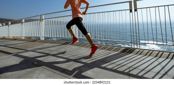 Healthy lifestyle fitness sports woman runner running up stairs on seaside trail - Shutterstock ID 2254892121