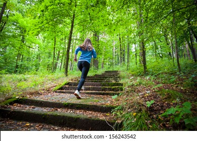 Healthy lifestyle - girl running, jumping in park 