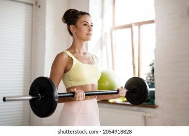 Healthy lifestyle gymnastics and a slim figure. Portrait of an instructor doing exercises for the body.  A woman does aerobics in a club. Fitness equipment in hand.