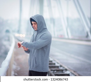 Healthy Lifestyle Man Checking  The Pulse  And Taking A Deep Breath. Sports Man Have A Training On The Bridge.  Middle Aged Man Checking Time On His Watch During The Training.