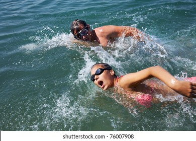 Healthy Lifestyle: Man And Woman Are Swimming Together In Open Water