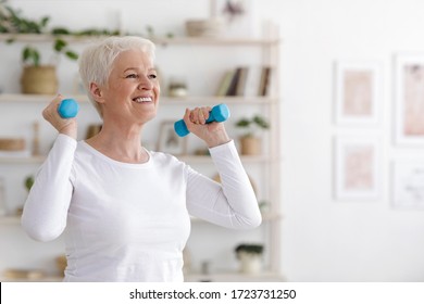 Healthy Lifestyle. Smiling Senior Lady Exercising With Dumbbells At Home, Free Space