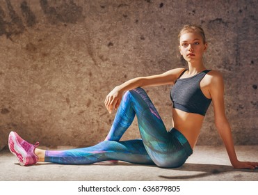 Healthy lifestyle and sport concepts. Woman in fashionable sportswear is doing exercise.