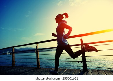 healthy lifestyle sports woman running wooden boardwalk sunrise seaside 