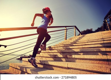 healthy lifestyle sports woman running up on stone stairs sunrise seaside - Powered by Shutterstock