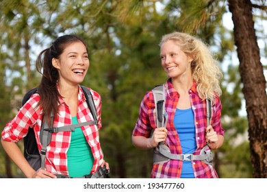 Healthy Lifestyle Women Laughing Hiking Walking Forest Doing Outdoor Activity Having Fun Together. Multicultural Group, Caucasian And Asian Girls Hikers.