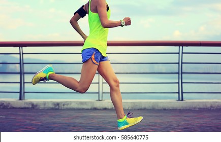 healthy lifestyle young fitness woman running at seaside - Shutterstock ID 585640775
