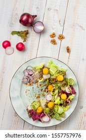healthy light salad with fried mozzarella cheese, fresh vegetables and crispy mix salad with lemon honey dressing and cranberry sauce. White wooden background with copy space, top view