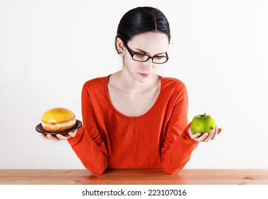 Healthy Living Concept: Choosing Between Doughnut Symbolizing Unhealthy Food And Green Apple Symbolizing Healthy Food