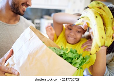 Healthy Living. Shot Of A Family Unpacking The Groceries In The Kitchen At Home.