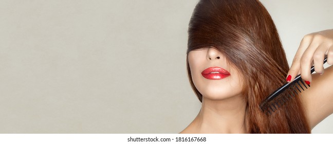 Healthy Long Hair. Beauty Model With Shinny Smooth Long Auburn Hair And Red Lips Combing It Across Her Eyes In A Sensual Gesture Conceptual Of Hair Care And Styling