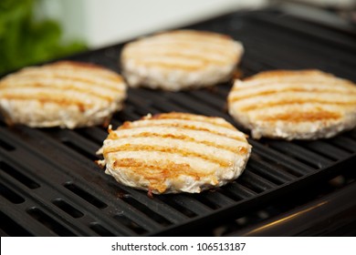 Healthy Low Fat Turkey Burgers Cooking On The Grill.