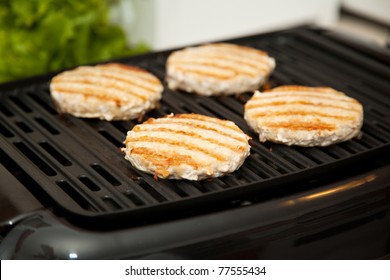 Healthy, Low-fat Turkey Burgers Cooking On Indoor Grill.