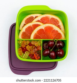 Healthy Lunch Box With Grapefruit, Cherry And Marmalade. High Quality Photo