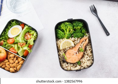 Healthy Lunch At Office Workplace. Takeaway Lunch Boxes With Nutrition Food - Fish, Vegetables And Fruits At Working Desk With Laptop.