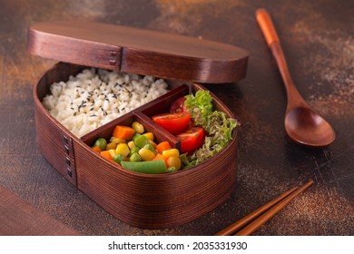 Healthy lunch in wooden japanese bento box. Balanced healthy food concept