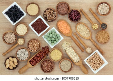 Healthy macrobiotic diet food with a selection of legumes, grains, seaweed, cereals, whole wheat pasta, seeds, wasabi and monkey nuts on hemp paper. Foods high in fibre, antioxidants and vitamins.