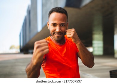 Healthy male boxer practicing by shadow boxing outdoors in city - Powered by Shutterstock