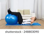 Healthy Man Doing Abs Exercise With A Pilates Ball