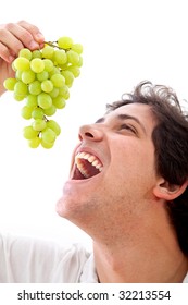 Healthy Man Eating Some Grapes Isolated Over White