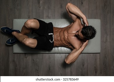 Healthy Man Exercising Abdominals On Foor - Powered by Shutterstock