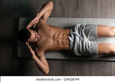 Healthy Man Exercising Abdominals On Foor