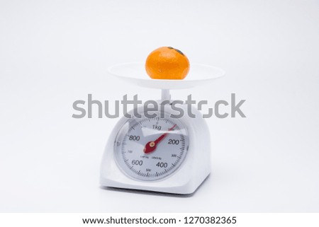 Healthy mandarin oranges on balance scale
