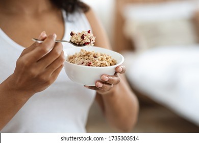 Healthy Meal Concept. Cropped Portrait Of Black Woman Eating Oatmeal With Fruits For Breakfast, Closeup