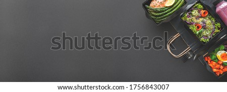 Healthy meal diet plan daily ready menu black background, fresh dishes in paper boxes, smoothie, fork knife on paper eco bag as food delivery service at home in office, flat lay, website photo banner.