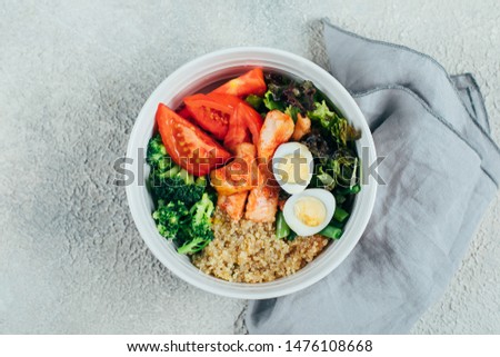 Healthy meal, food concept. Fish salad bowl with salmon, couscous, salad mix, green beans, broccoli, tomatoes, quail eggs and sauce on cincrete table background. Top view Stock photo © 