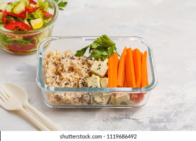 Healthy Meal Prep Containers With Brown Rice, Tofu And Vegetable Salad Overhead Shot With Copy Space. Healthy Vegan Food Concept.