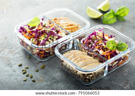 Healthy meal prep containers with quinoa, chicken and cole slaw