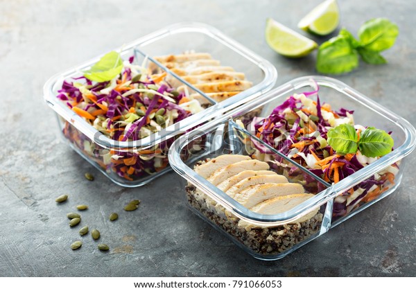 Healthy meal prep containers with quinoa, chicken\
and cole slaw
