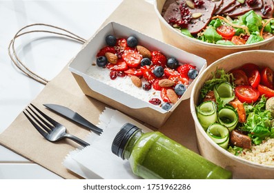 Healthy meal slimming diet plan daily ready menu background, organic fresh dishes and smoothie, fork knife on paper eco bag as food delivery courier service at home in office concept, close up view.