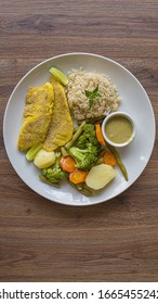 Healthy Meal In A White Plate With Carrots, Brocolli, Potate, Rice And Fish Steak