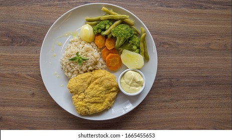 Healthy Meal In A White Plate With Carrots, Brocolli, Potate, Rice And Chicken Steak