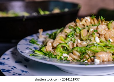 healthy meal with whole wheat pasta with zucchini and cheese on a plate