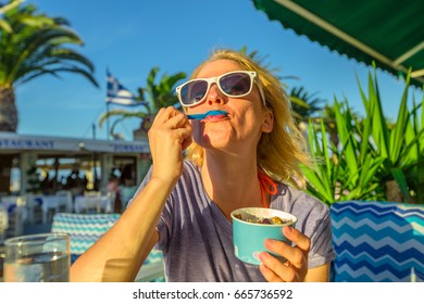 Healthy Mediterranean Diet. Blonde Caucasian Female Eating Healthy Food Outdoor. Europe Summer Vacation. Lifestyle Woman Eating Typical Yogurt Greek In Koroni, Peloponnese, Greece. Summer Holidays.